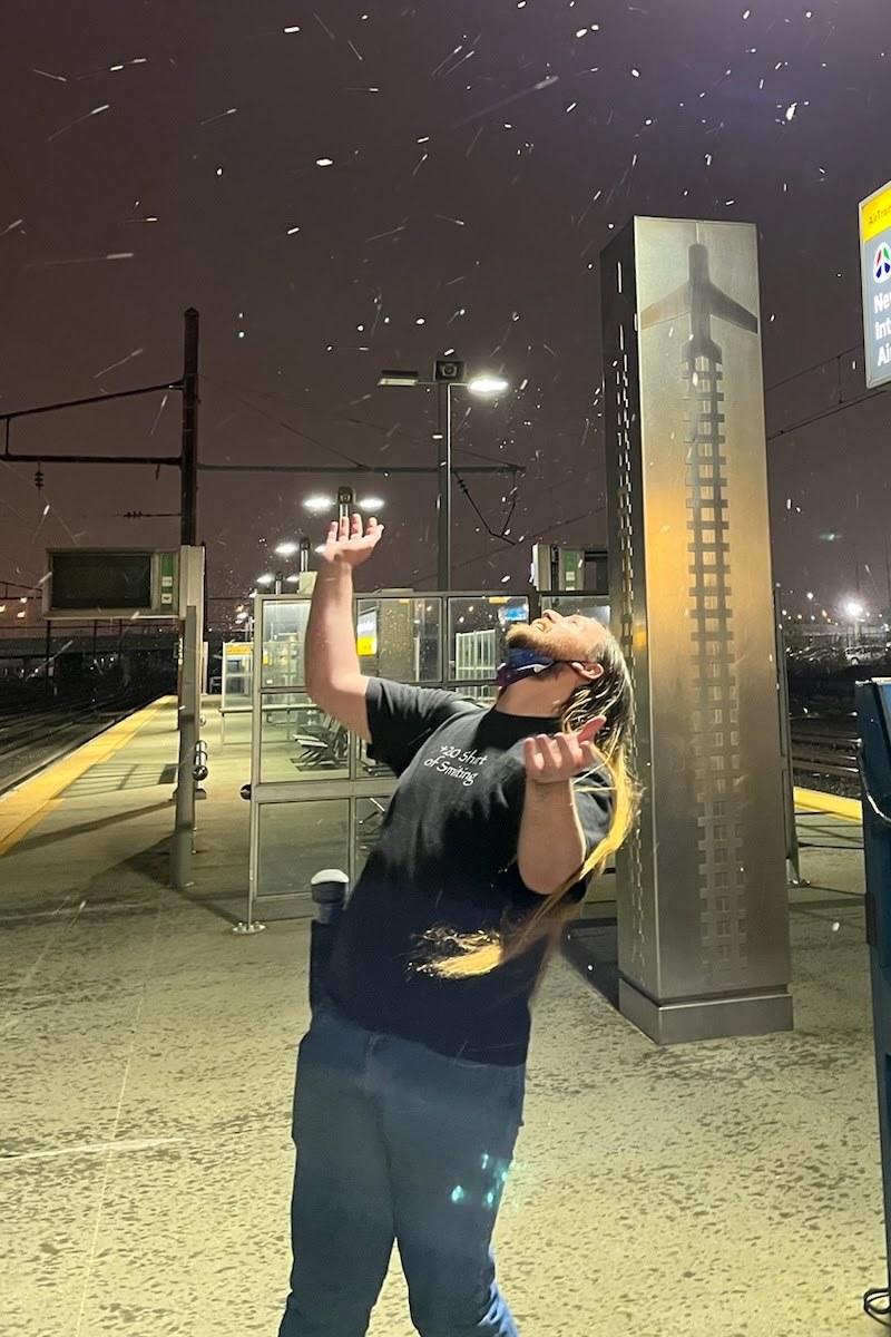 Kyle chasing snowflakes on a train platform